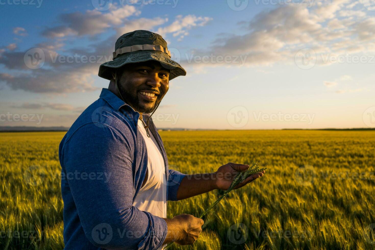 Afro farmer standing in a wheat field photo