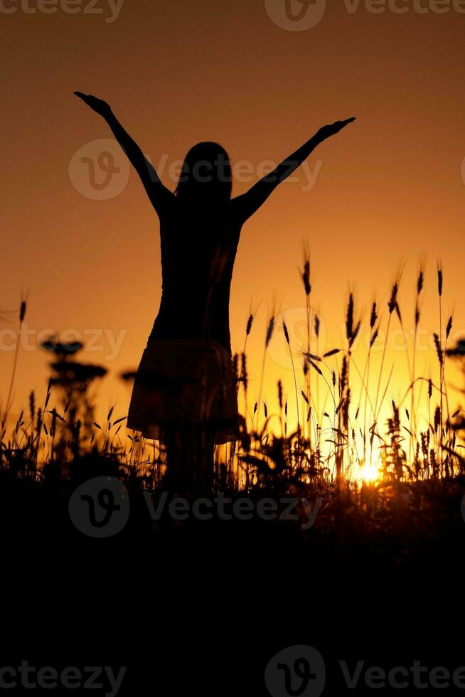 Silhouette of a woman at sunset photo