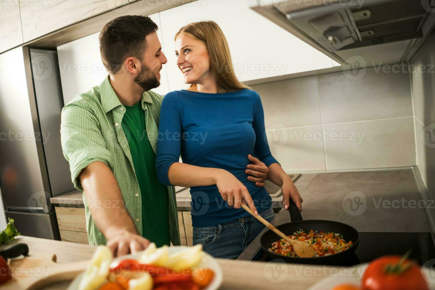 A young couple cooking together photo