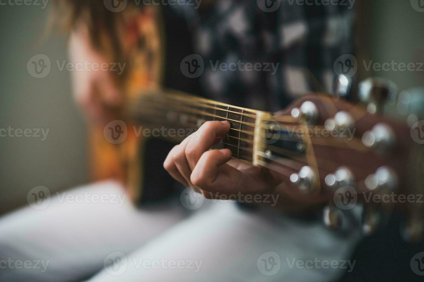 A teenage girl playing guitar photo