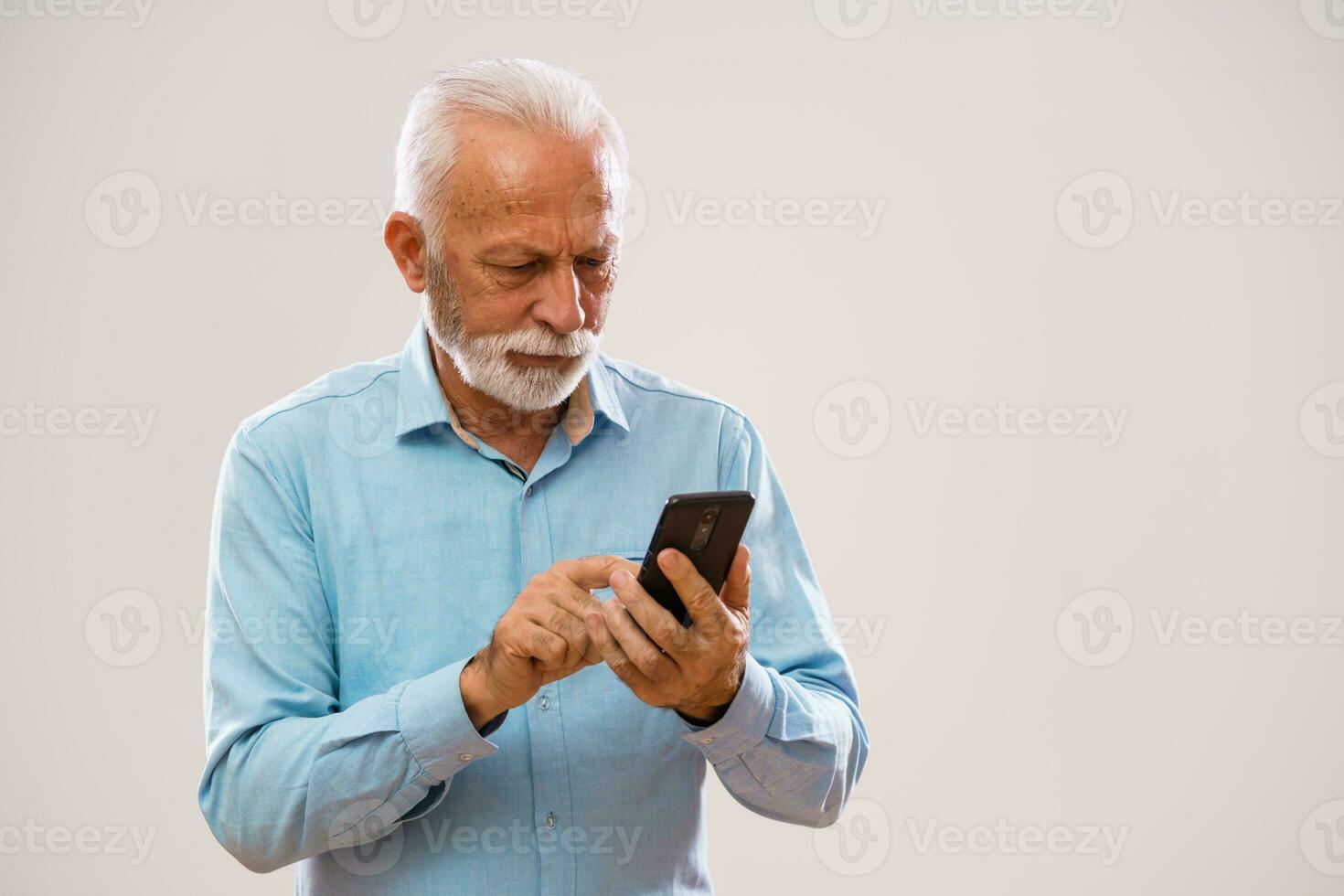 Senior man holding a phone photo