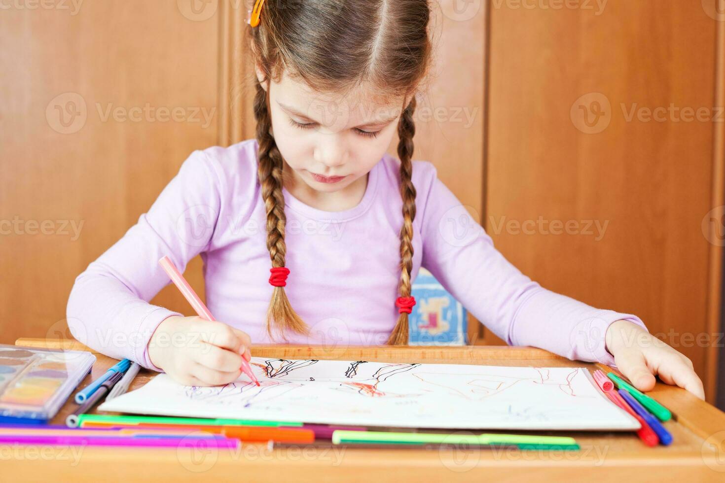 A little girl drawing photo