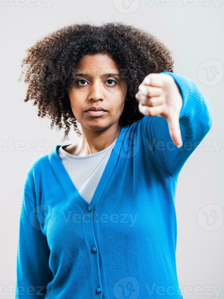 Portrait of unhappy Afro woman with a blue cardigan photo