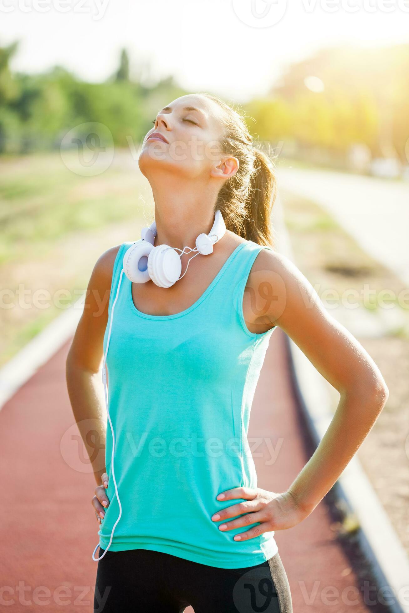 a-woman-on-a-running-track-23915987-stock-photo-at-vecteezy
