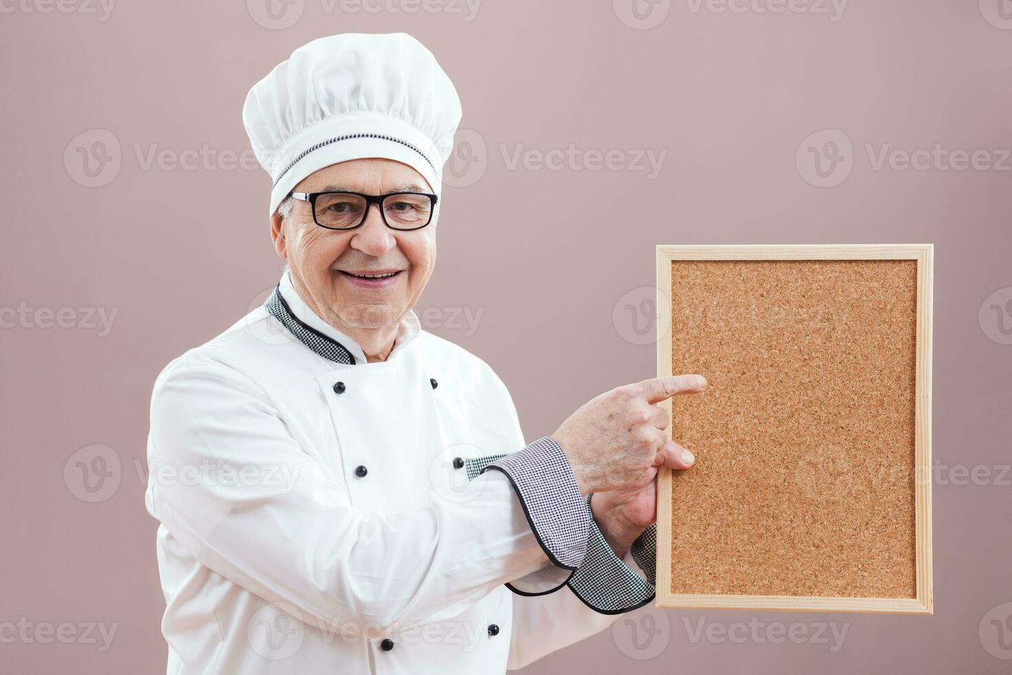 A chef pointing to a display photo