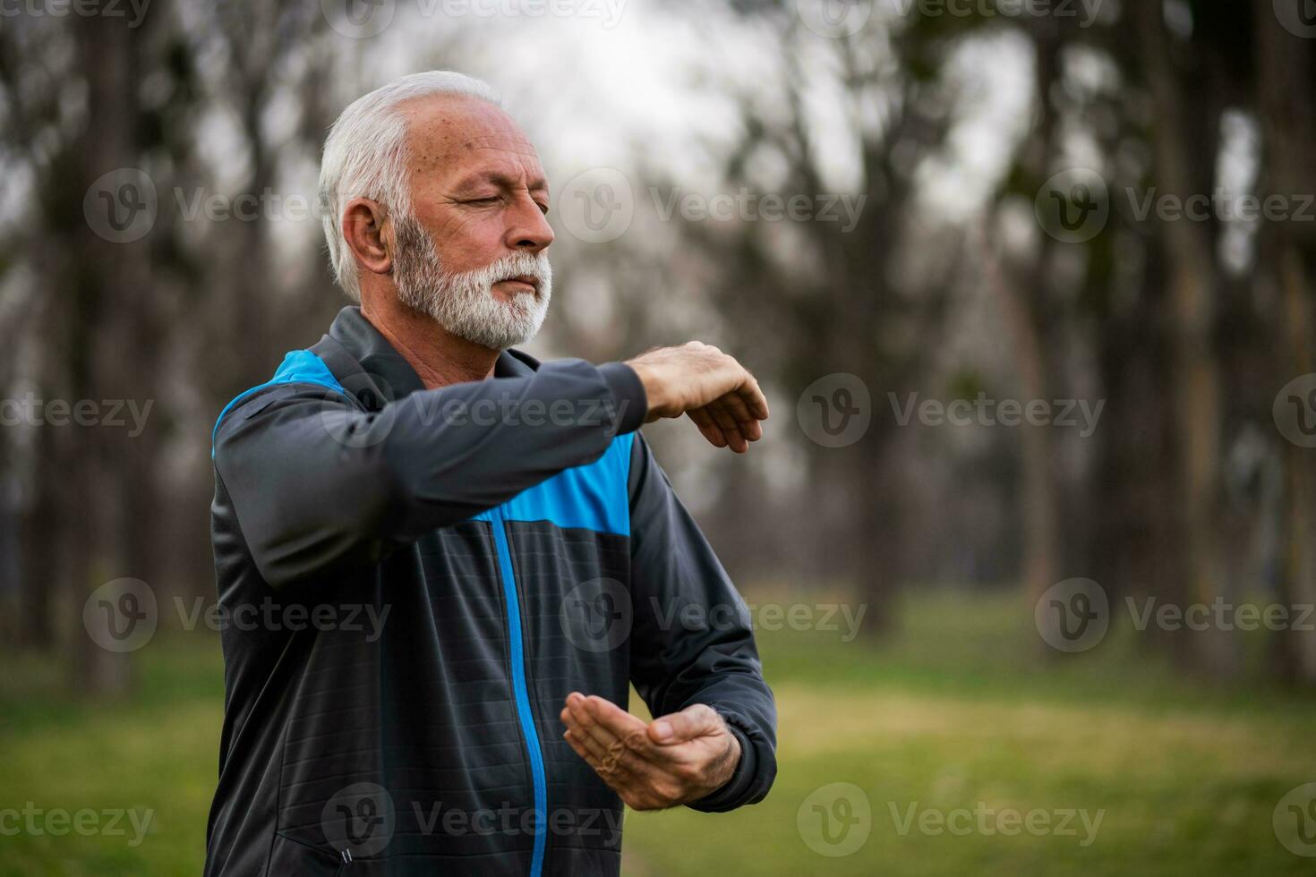 A senior man doing physical exercises photo