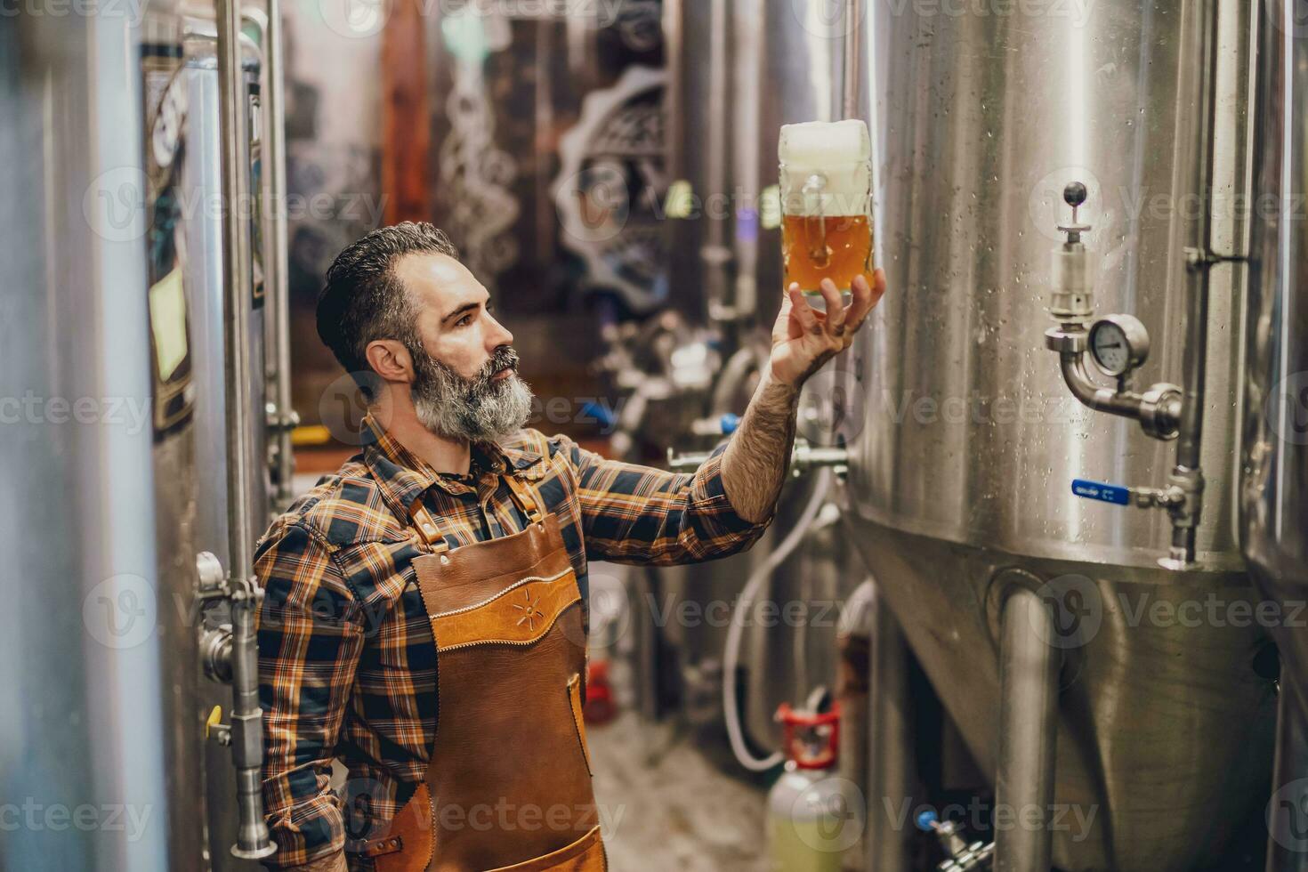 un cervecería Maestro supervisando el cerveza producción proceso foto