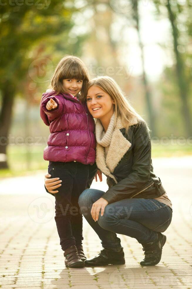 A mother with her daughter in the park photo