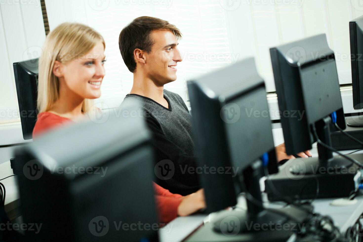 Students learning in a computer lab photo