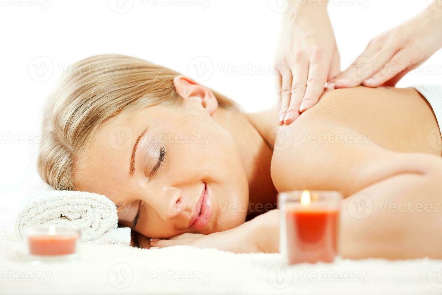 Young woman relaxing after massage on spa treatment photo