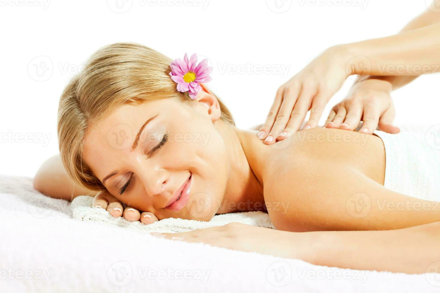 Young woman relaxing after massage on spa treatment photo