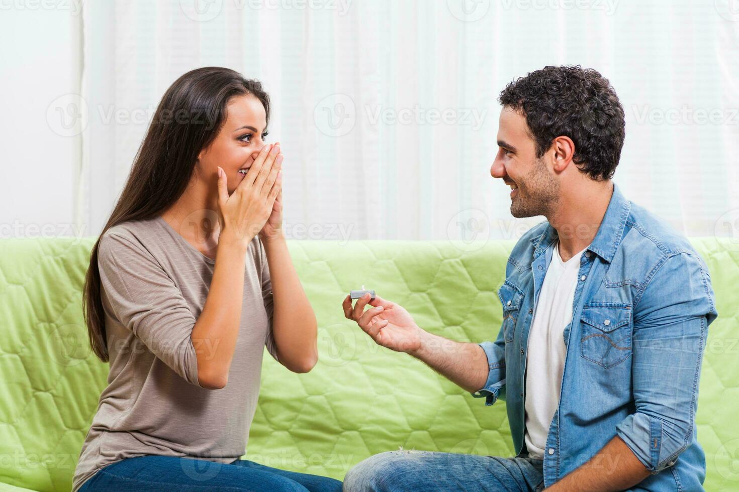 Portrait of a young couple. The man is proposing to the woman. photo