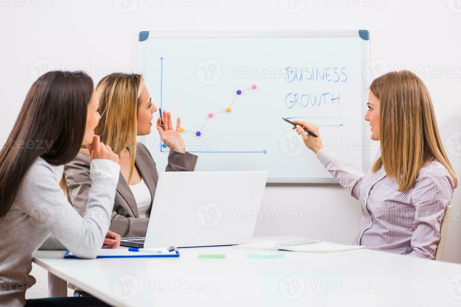 Businesswomen discussing business plan photo