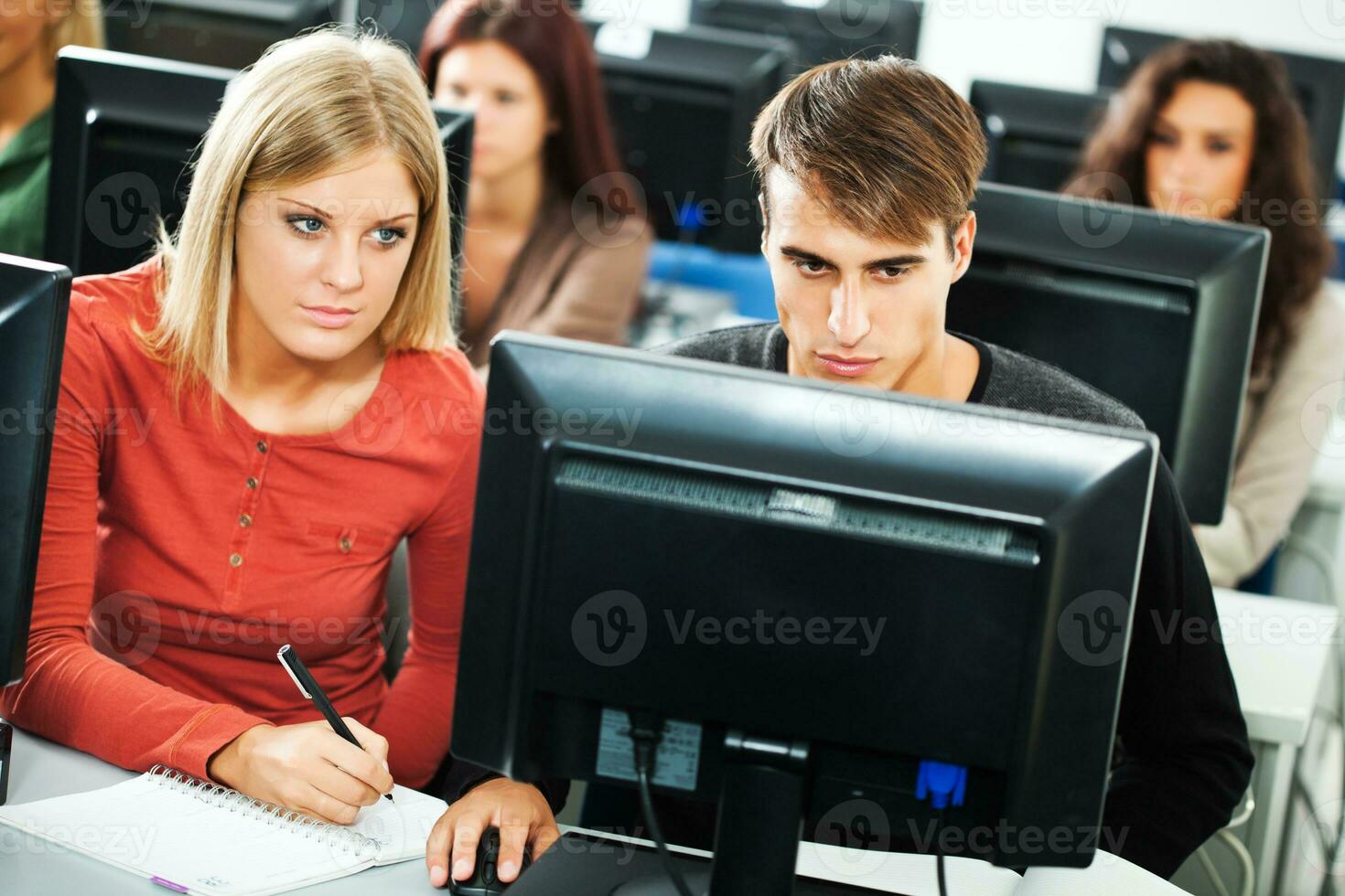 Students learning in a computer lab photo