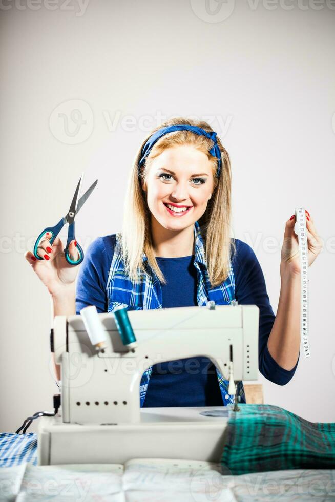 A woman with a sewing machine photo