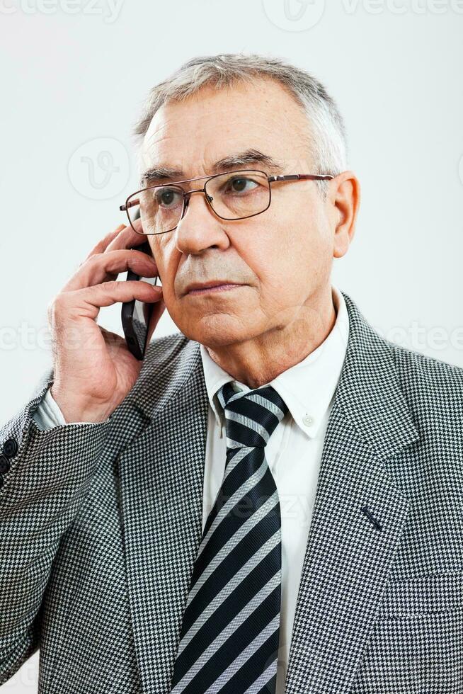 Portrait of a senior businessman on the phone photo