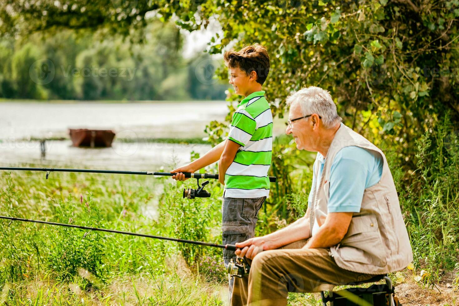 A grandfather and his nephew fishing photo