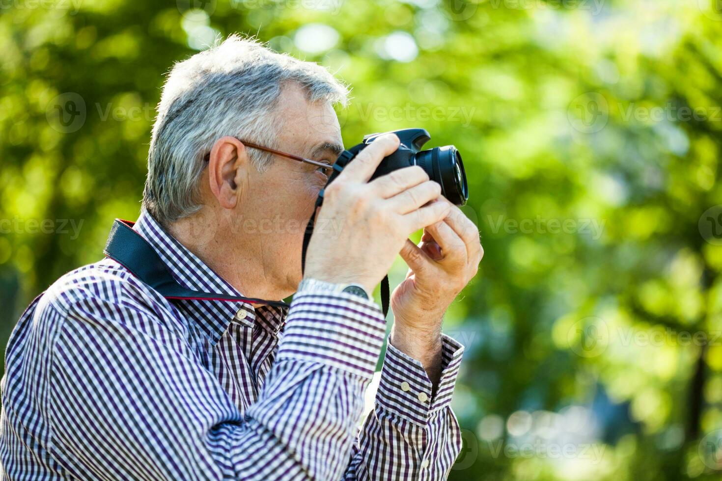 Portrait of a senior man on the park photo
