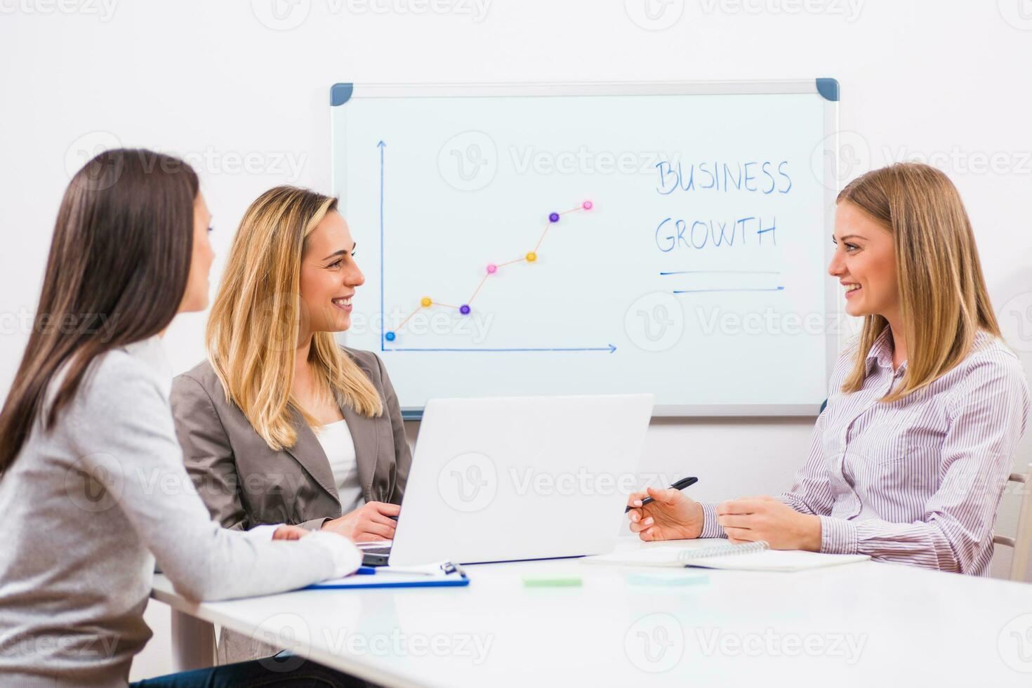 Businesswomen discussing business plan photo