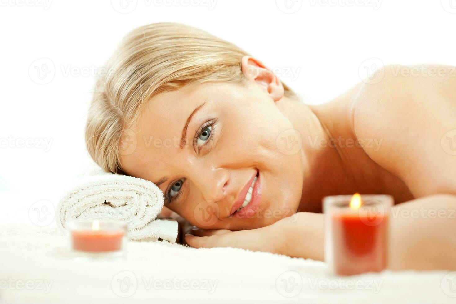 Young woman relaxing after massage on spa treatment photo