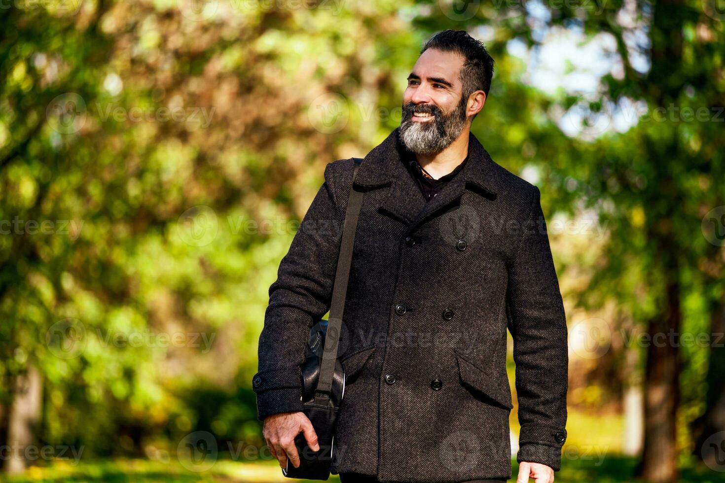 Young man walking on the park during fall photo