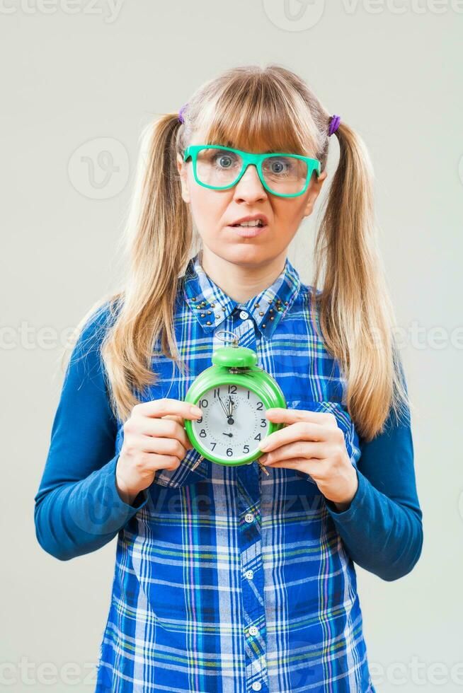 Portrait of a woman with green glasses and a clock photo
