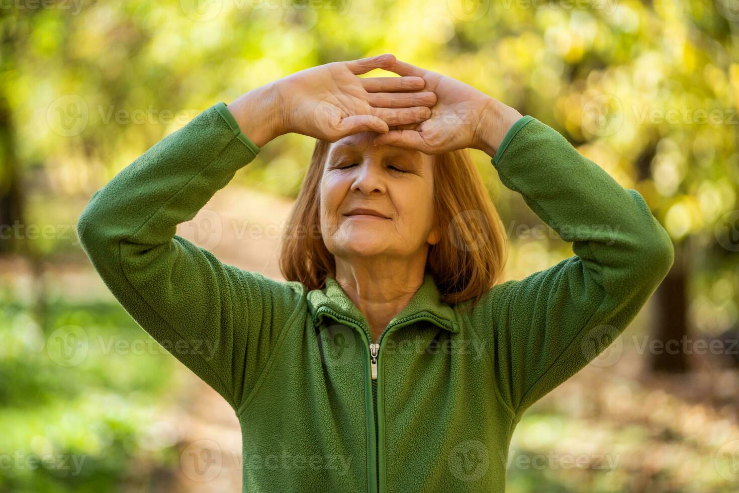 A senior woman doing physical exercises photo