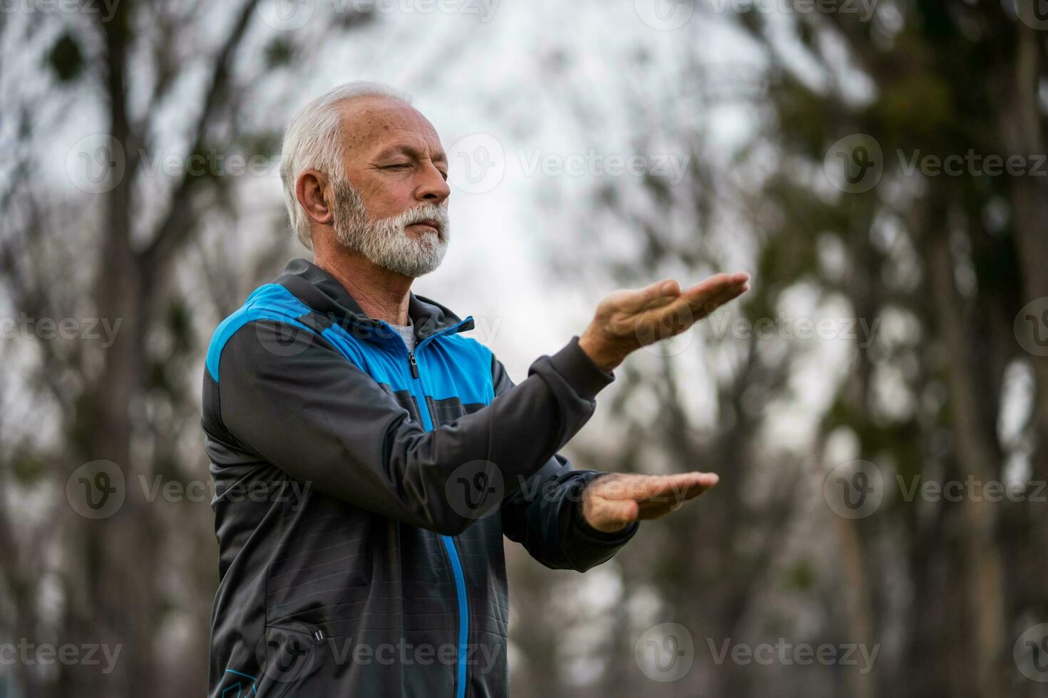 A senior man doing physical exercises photo