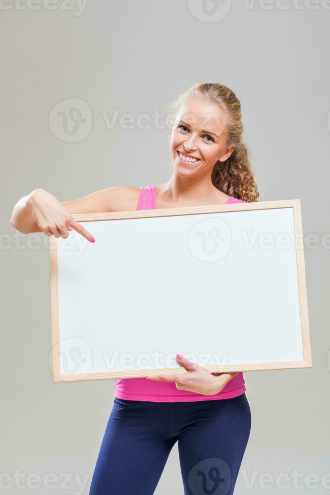 A woman pointing to a display photo