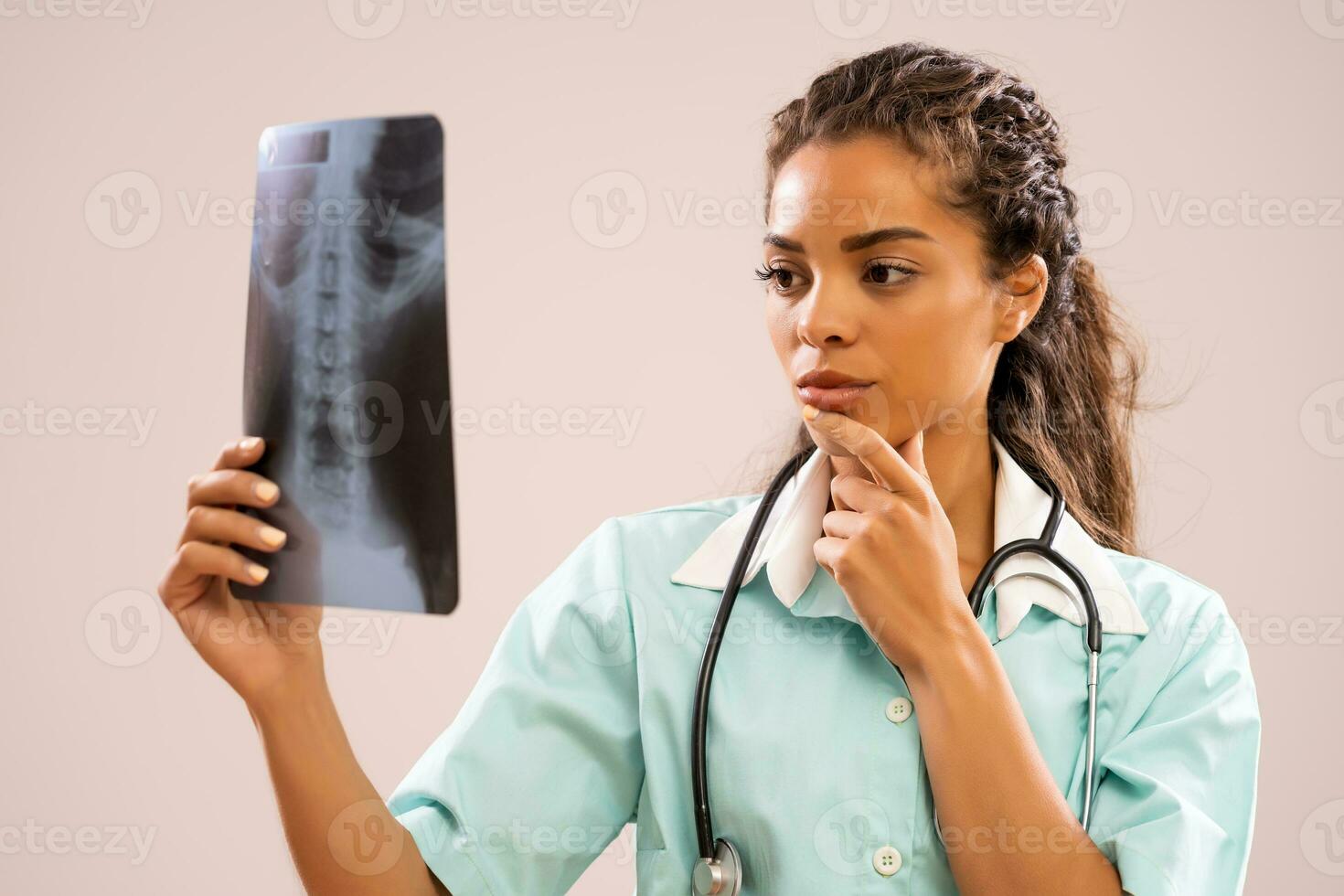 A nurse looking at a x-ray image photo