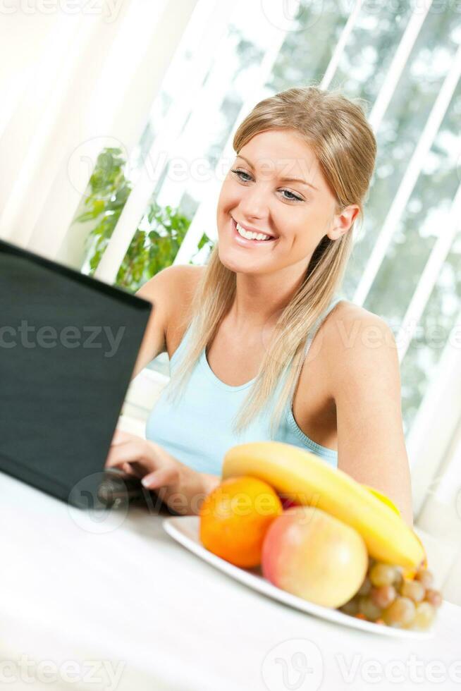 Young blonde woman with fruit for health and wellness concept photo