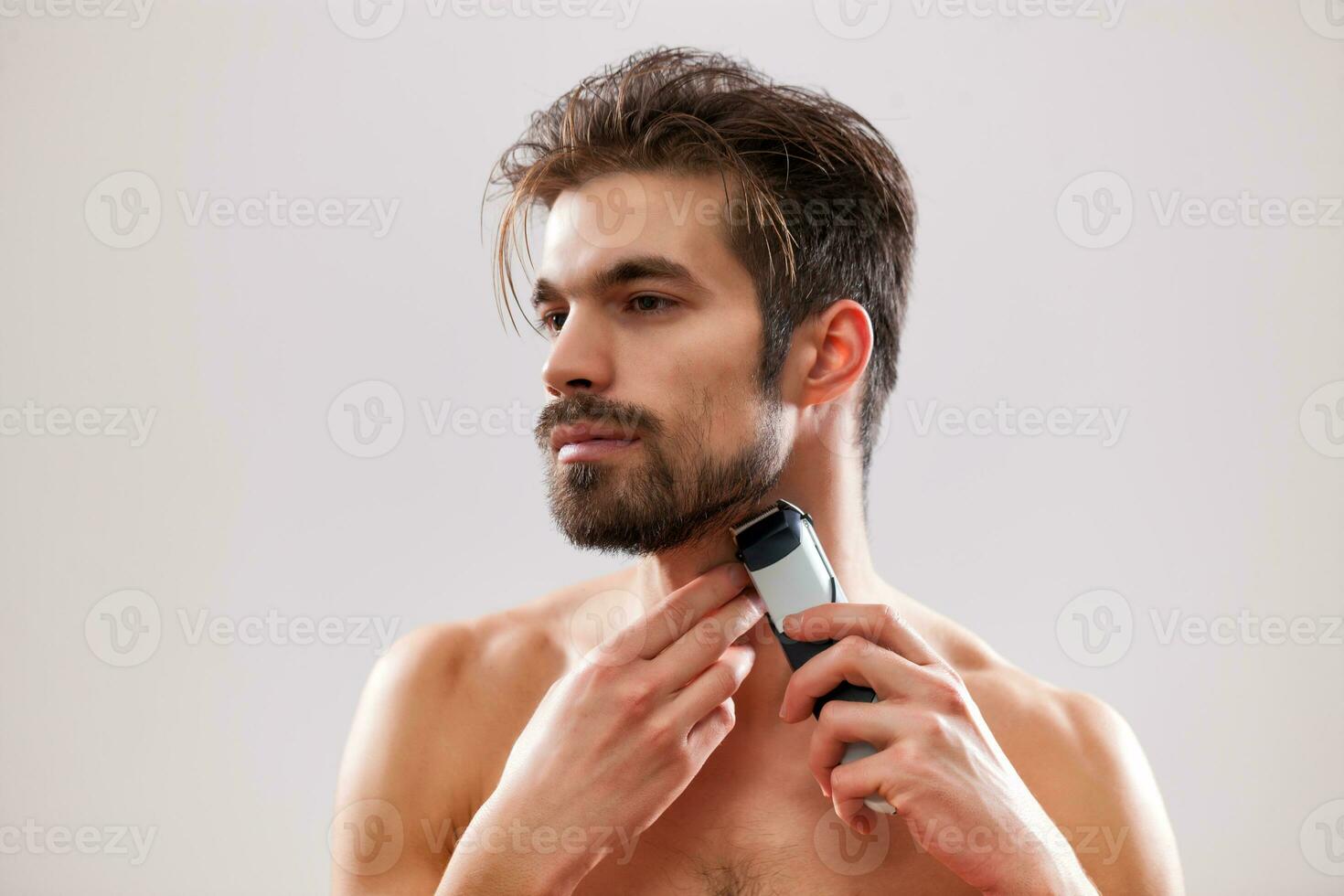 A man grooming his beard photo