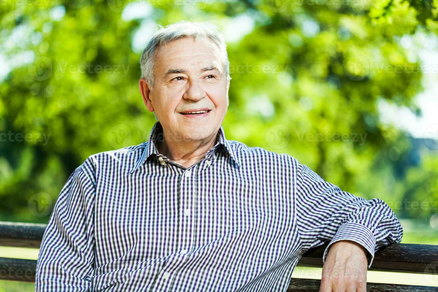 Portrait of a senior man on the park photo