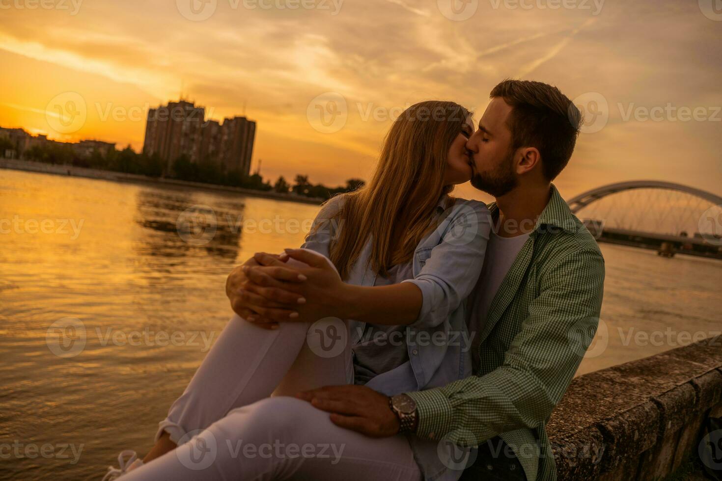 A young couple over the sunset photo