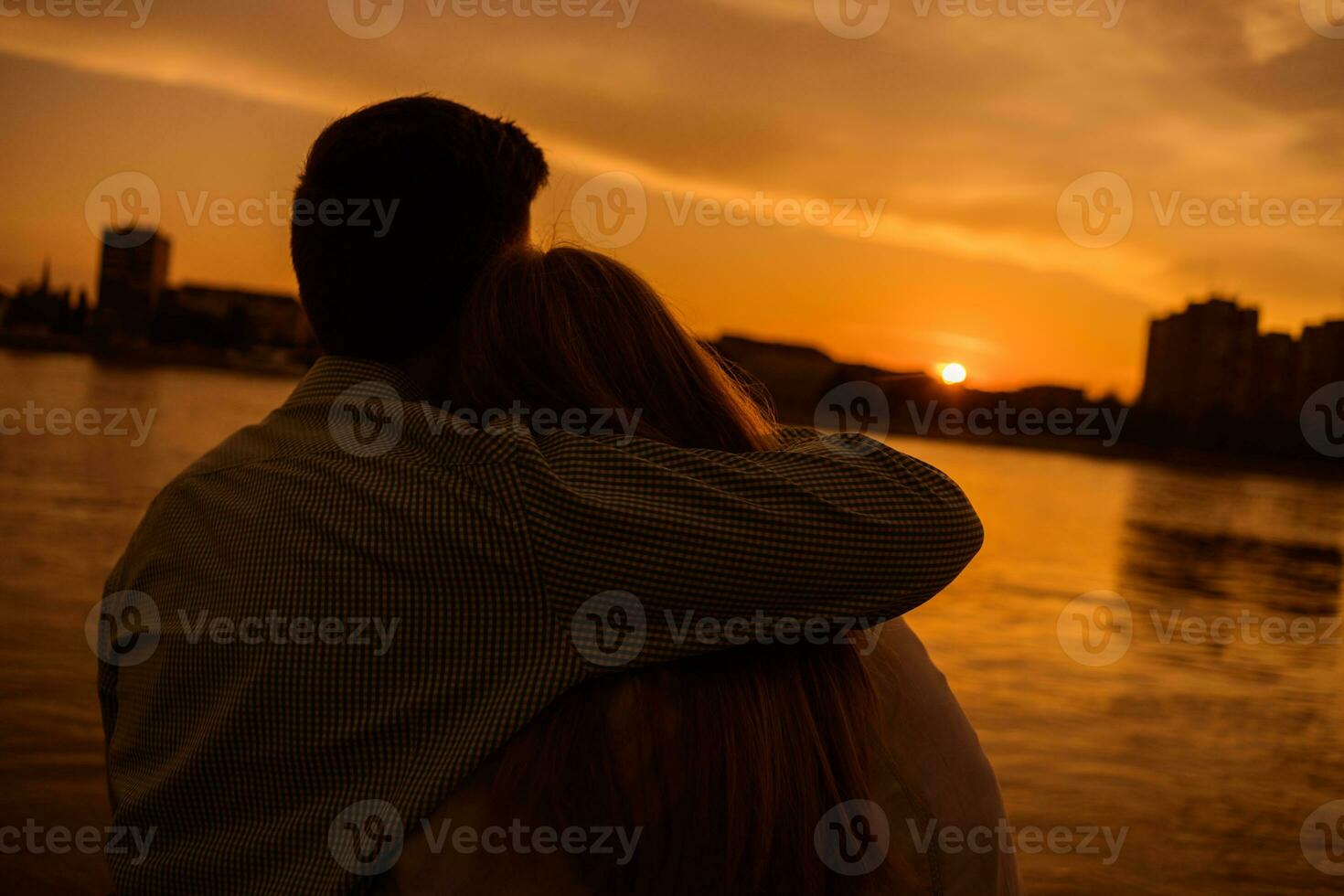 A young couple over the sunset photo