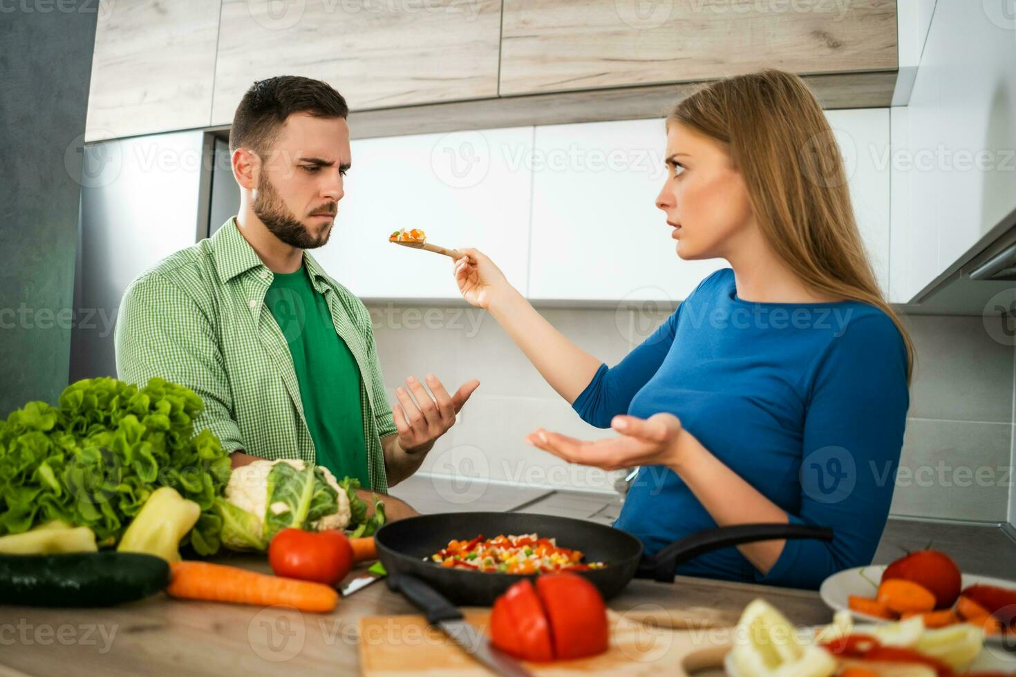 A young couple cooking together photo