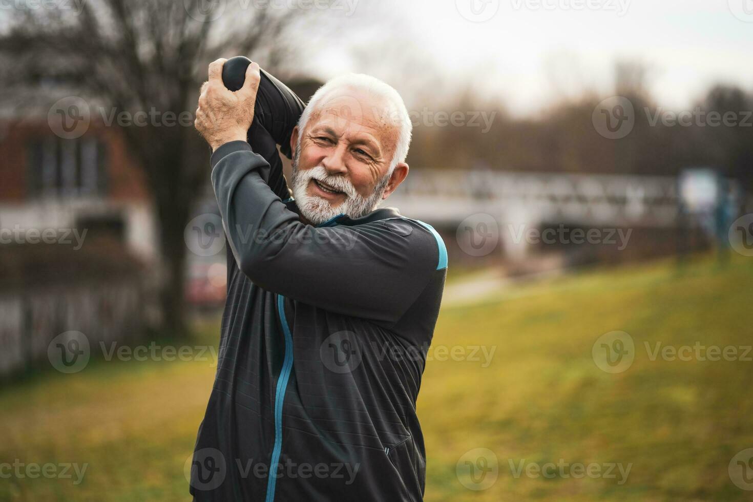A senior man doing physical exercises photo