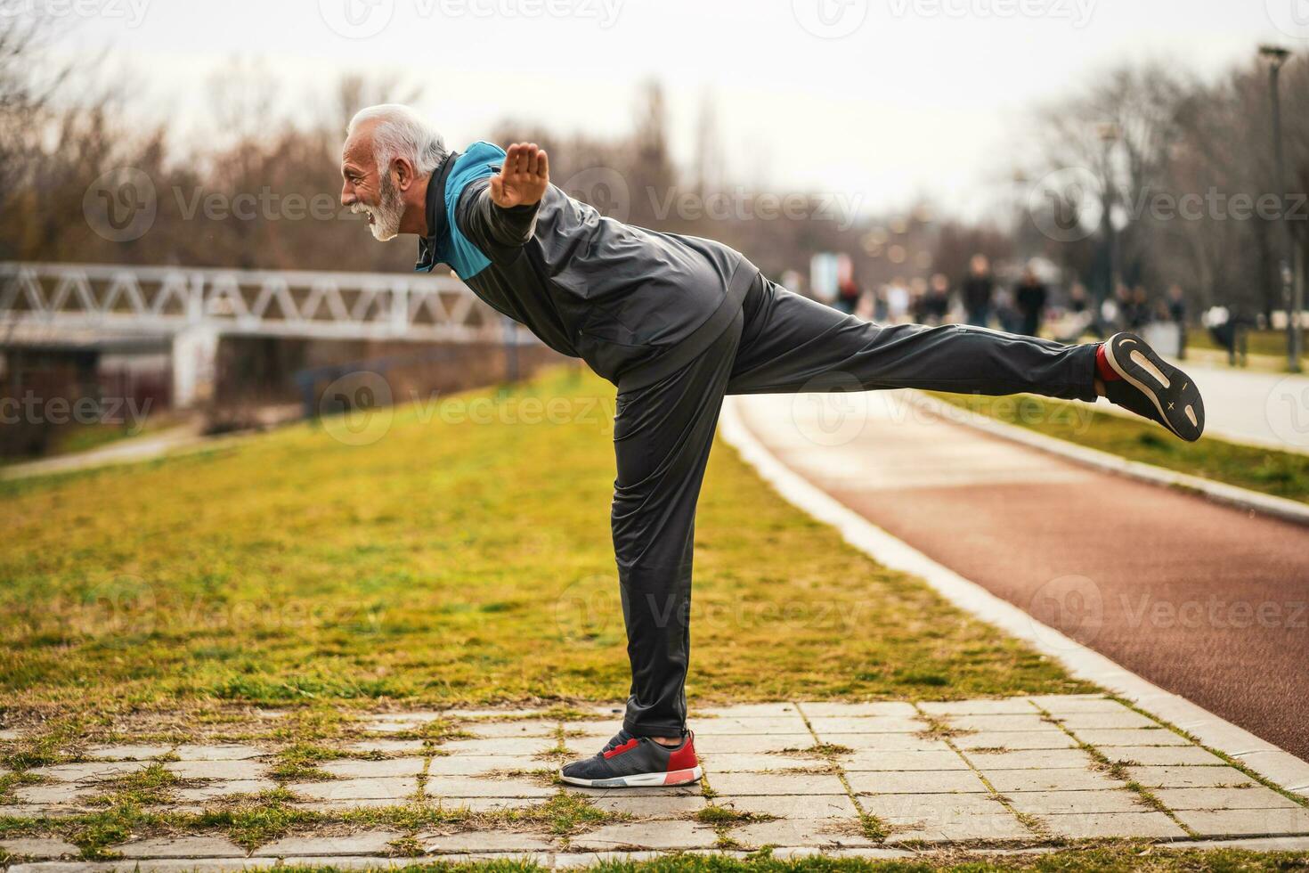 A senior man doing physical exercises photo