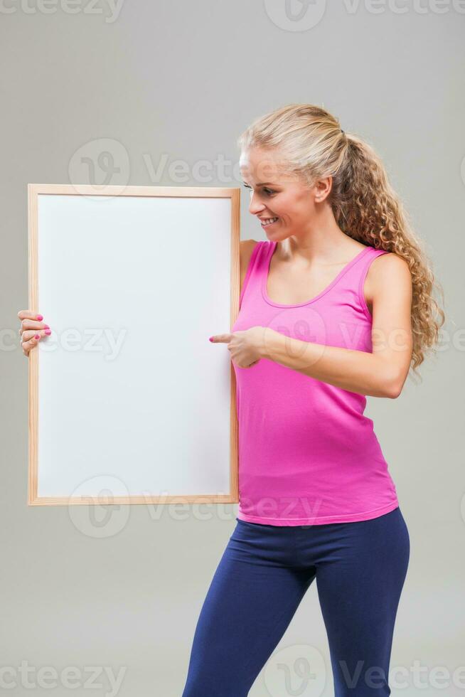 A woman pointing to a display photo
