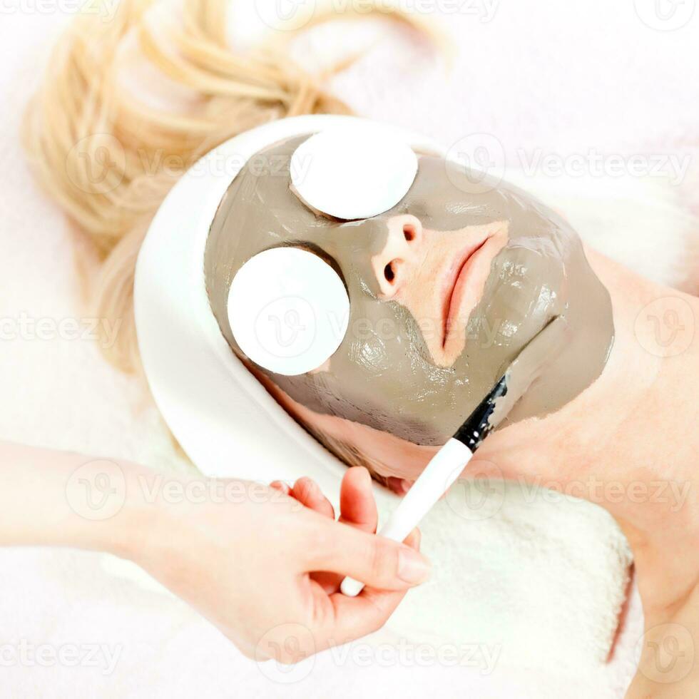 Mature woman having a face treatment photo