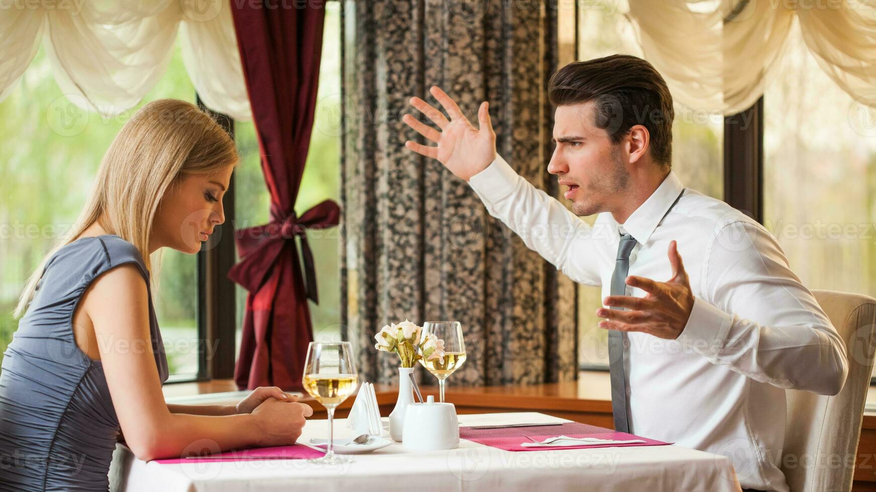 A couple having dinner at a restaurant photo