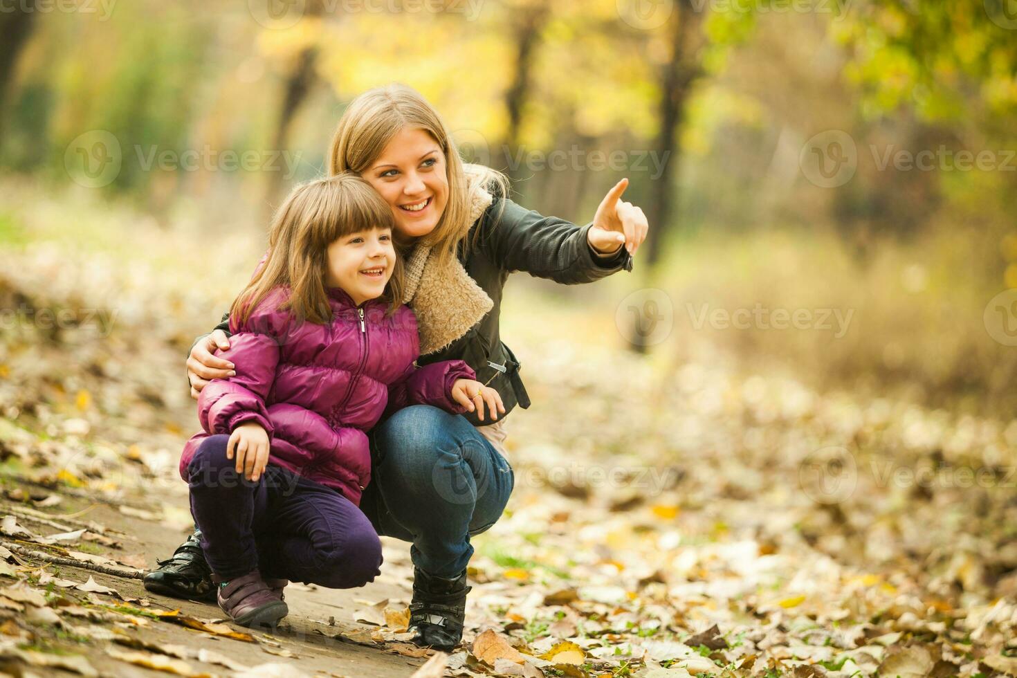 A mother with her daughter in the park photo