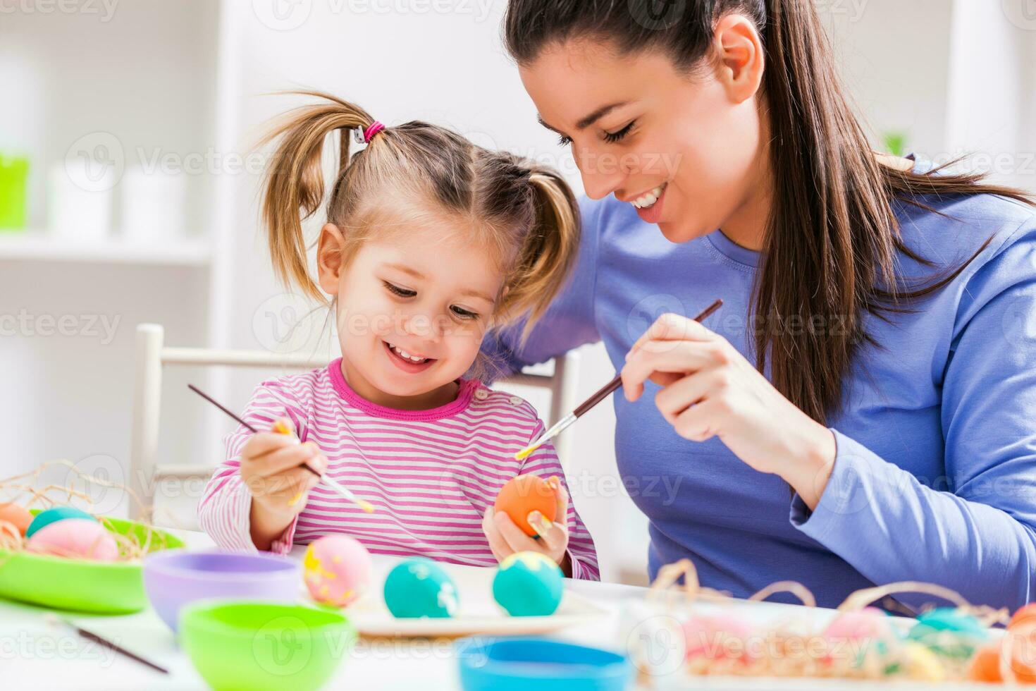 A mother and daughter painting eggs photo