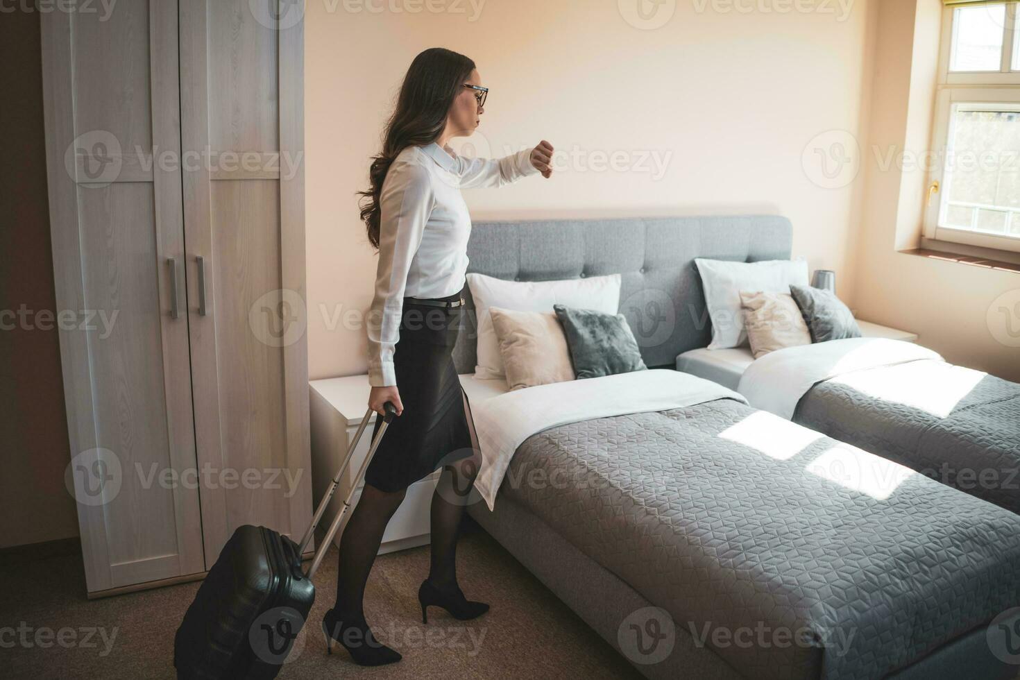 A businesswoman in her room after returning from a trip photo