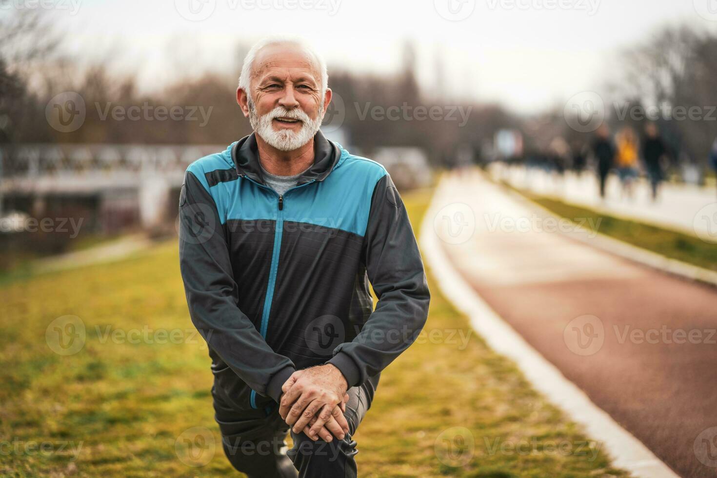 A senior man doing physical exercises photo