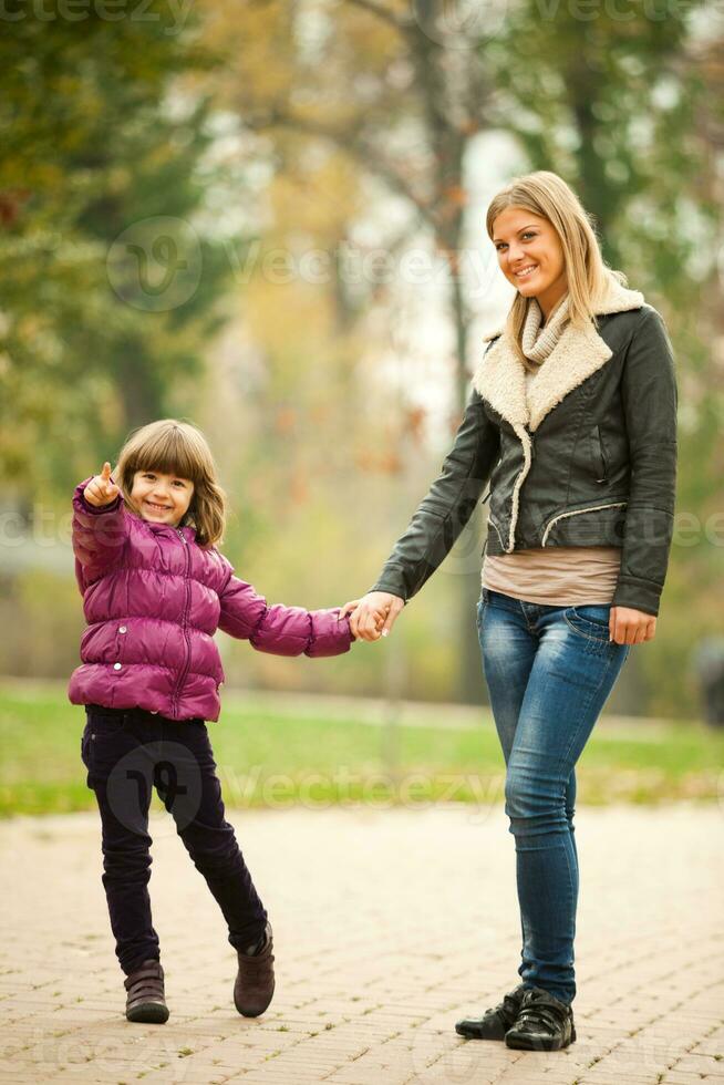 A mother with her daughter in the park photo