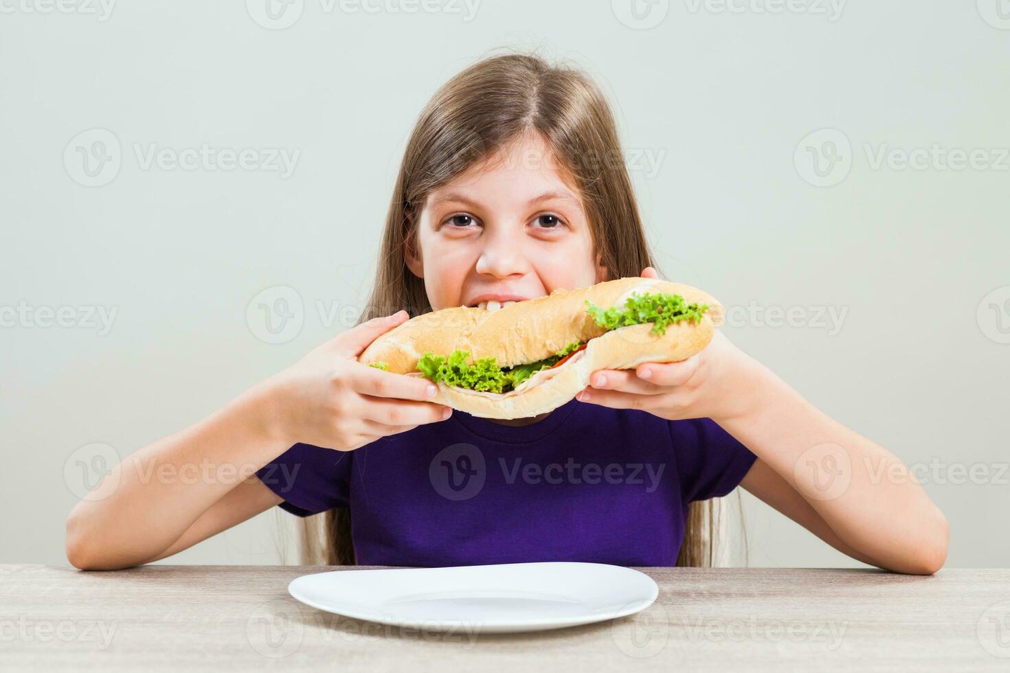 A girl eating a sandwich photo