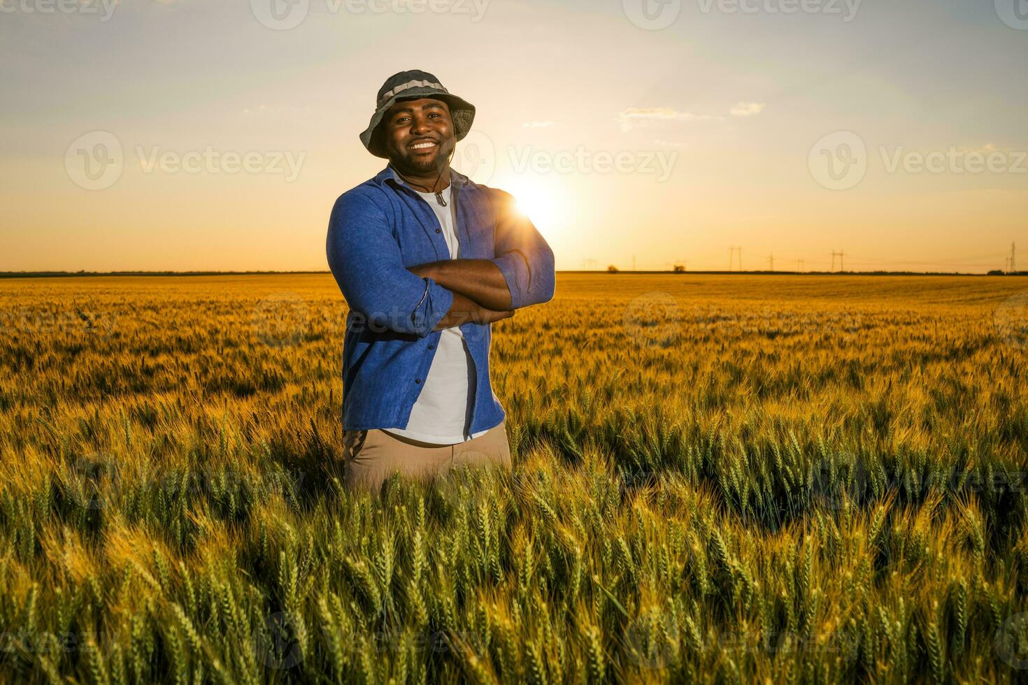 Afro farmer standing in a wheat field photo