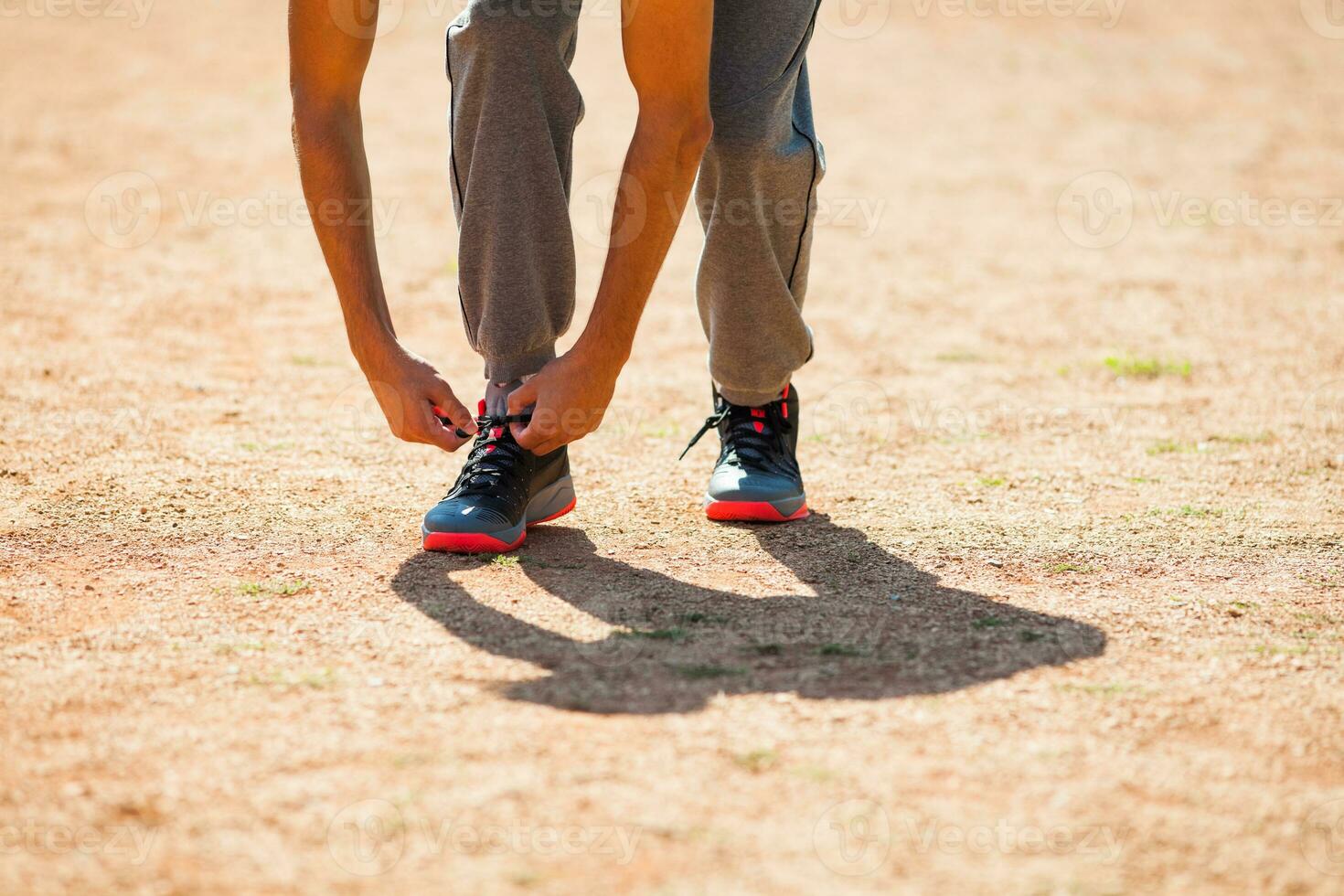 A man tying his shoelaces photo