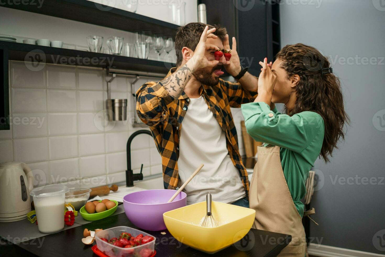 Happy multiethnic couple cooking together photo
